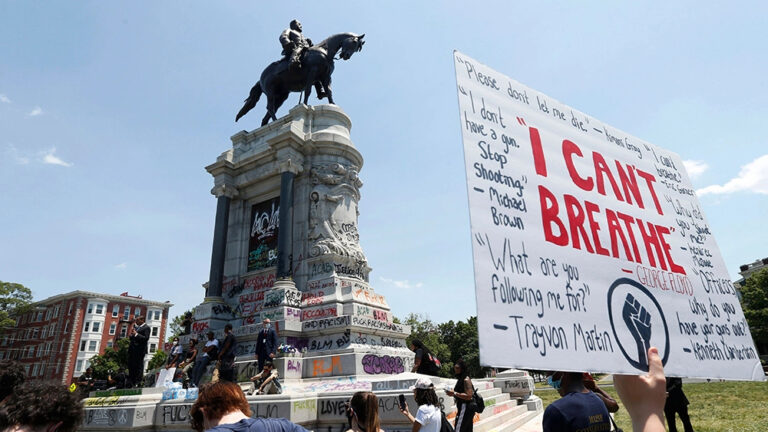 Robert E Lee statue with protestors